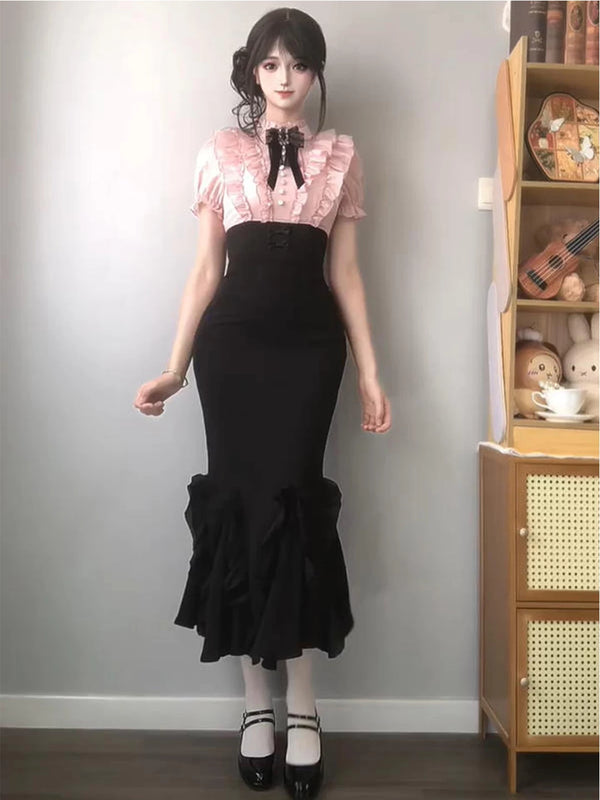 Black and pink mermaid one-piece dress with a lace-trimmed pink bodice and ruffled hem.