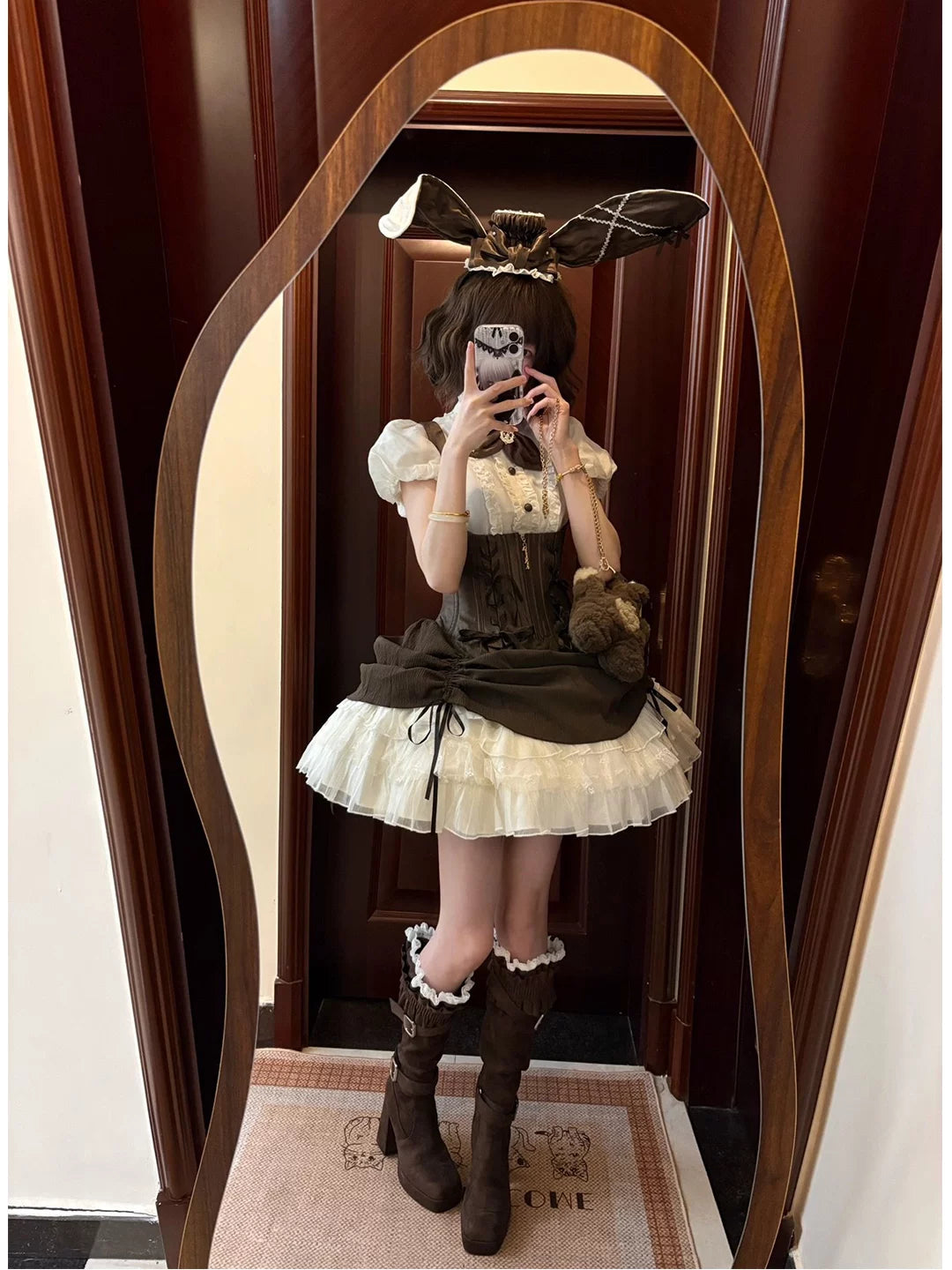 Brown Gothic Lolita JSK coordinate with rabbit-ear hat, bow tie and layered skirt in a mirror.