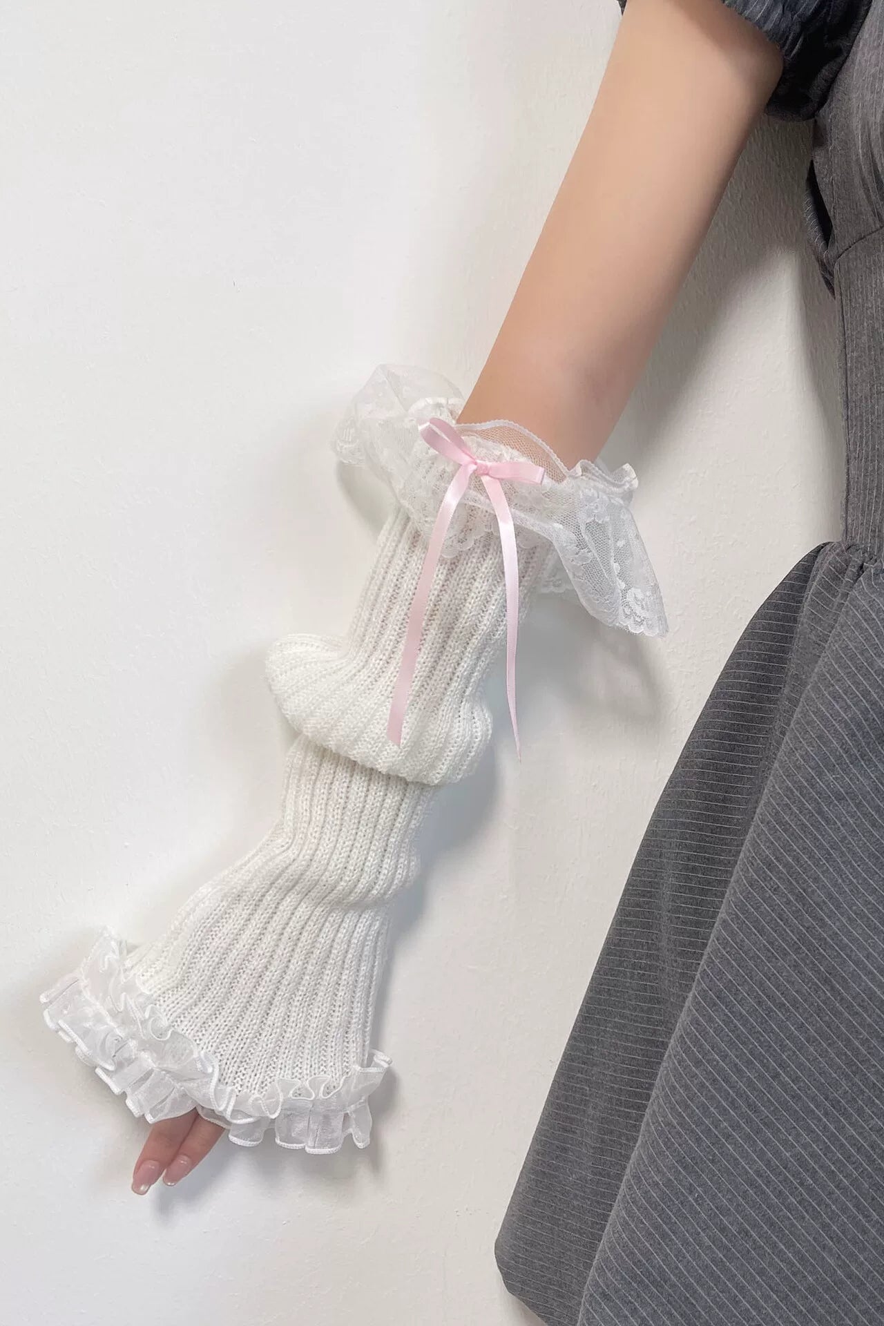White ribbed hand sleeves with ruffled lace cuffs and pink ribbon bows