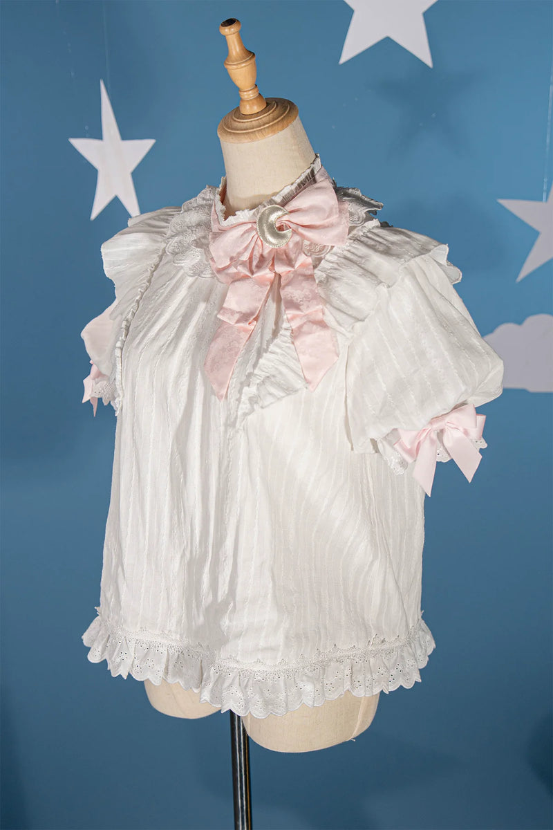 White cotton layering blouse with pink bow and ruffled neckline
