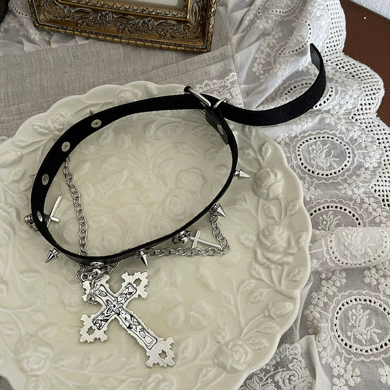Sock Noble black legwear with silver cross charms, chains, and dark flared sock covers.