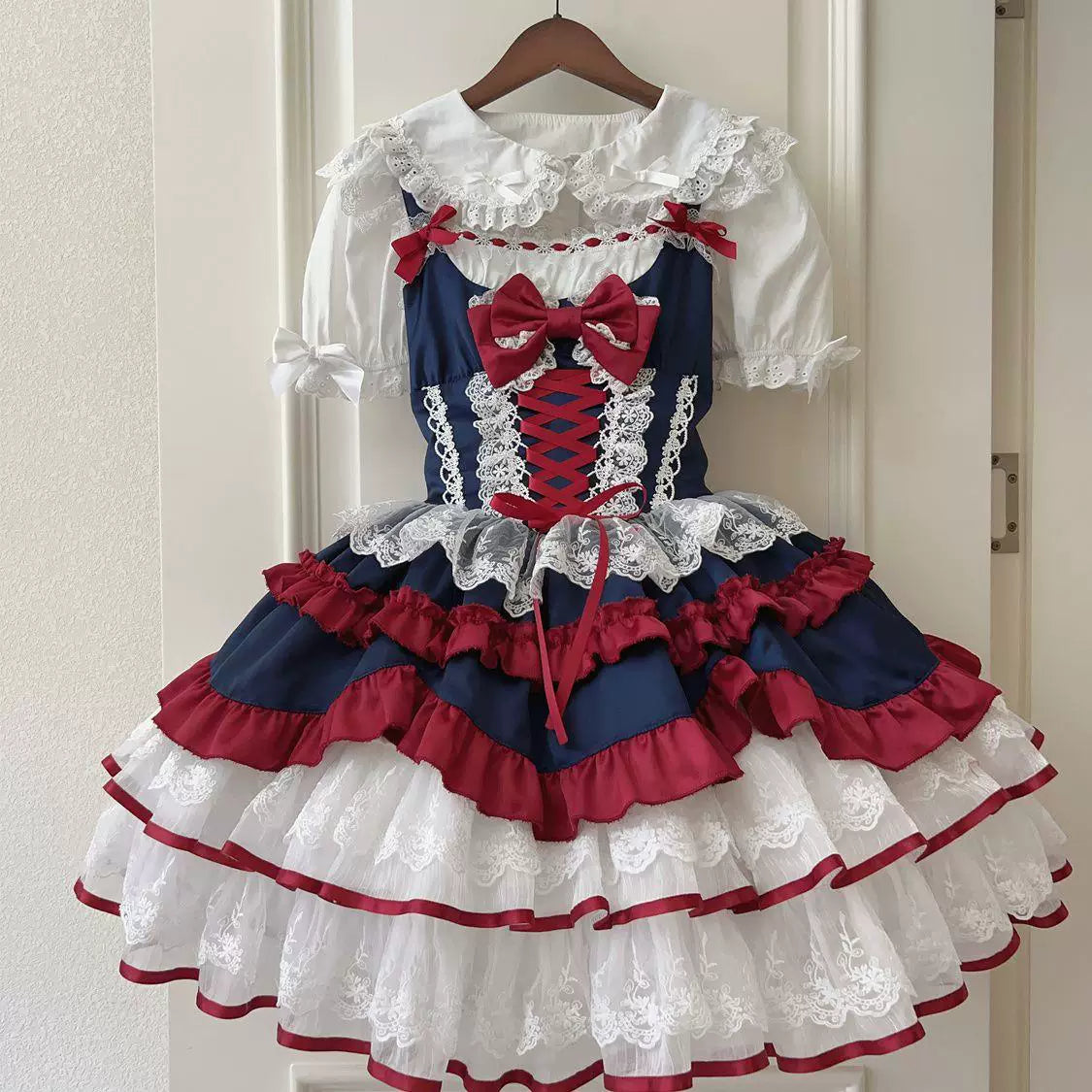 Blue JSK dress with white lace, red ribbon bows and layered ruffles