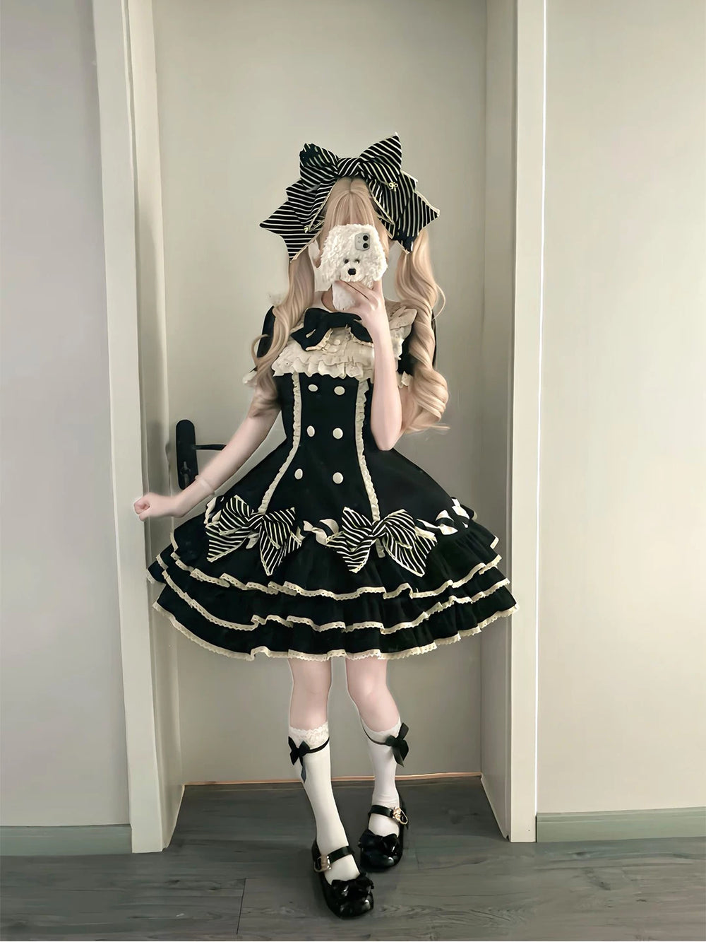 Black tiered Lolita dress with striped bows, white ruffle trim and bow headwear.