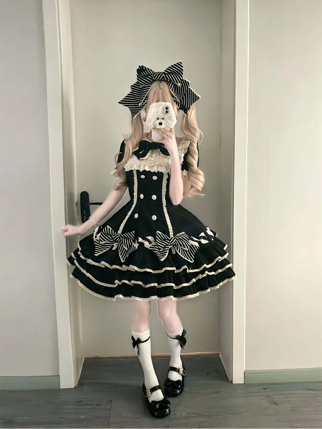 Black tiered Lolita dress with striped bows, white ruffle trim and bow headwear.