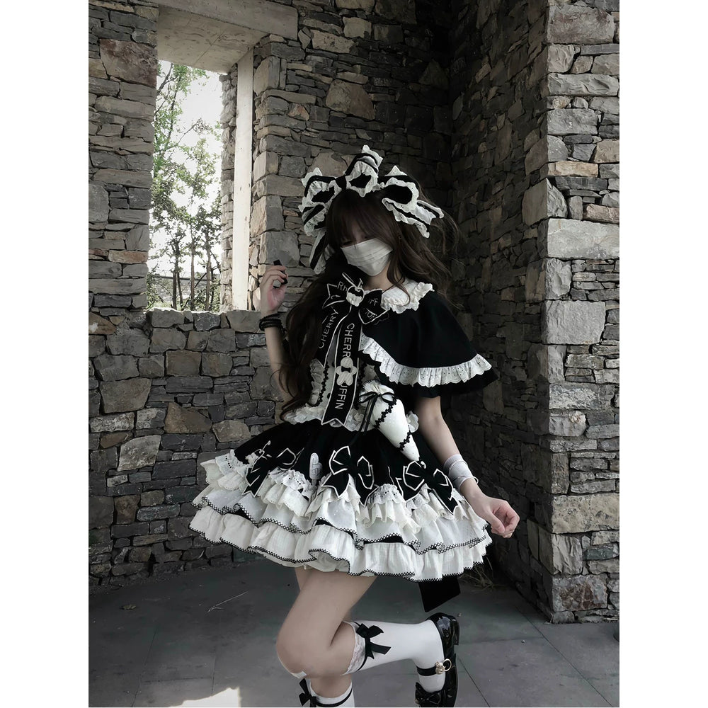 Black JSK set with white-ruffled cape and layered accessories