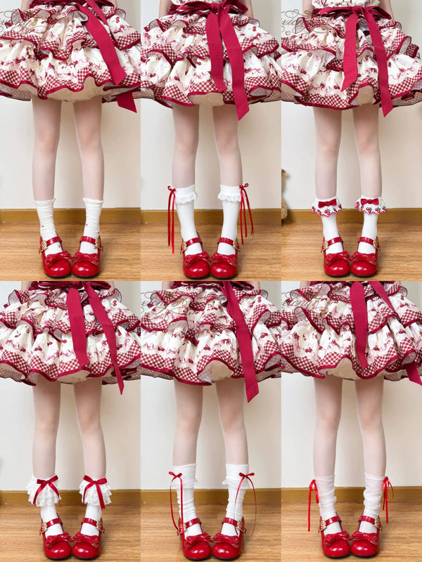 Red-and-white socks with lace, ribbon and bow details shown with red shoes.