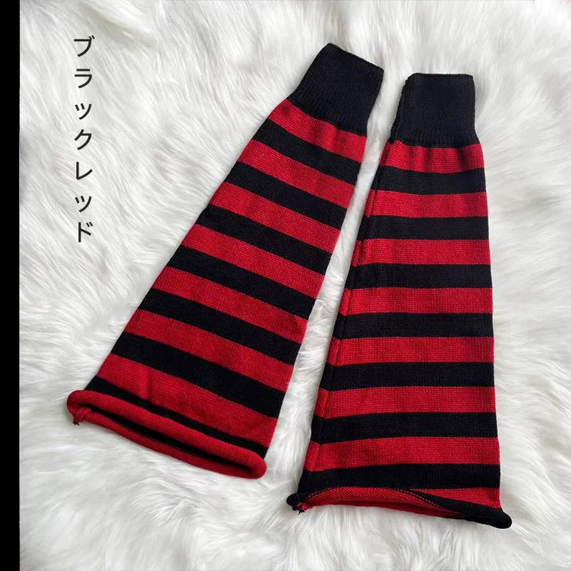 Black-and-red striped knitted sock covers laid on white faux fur