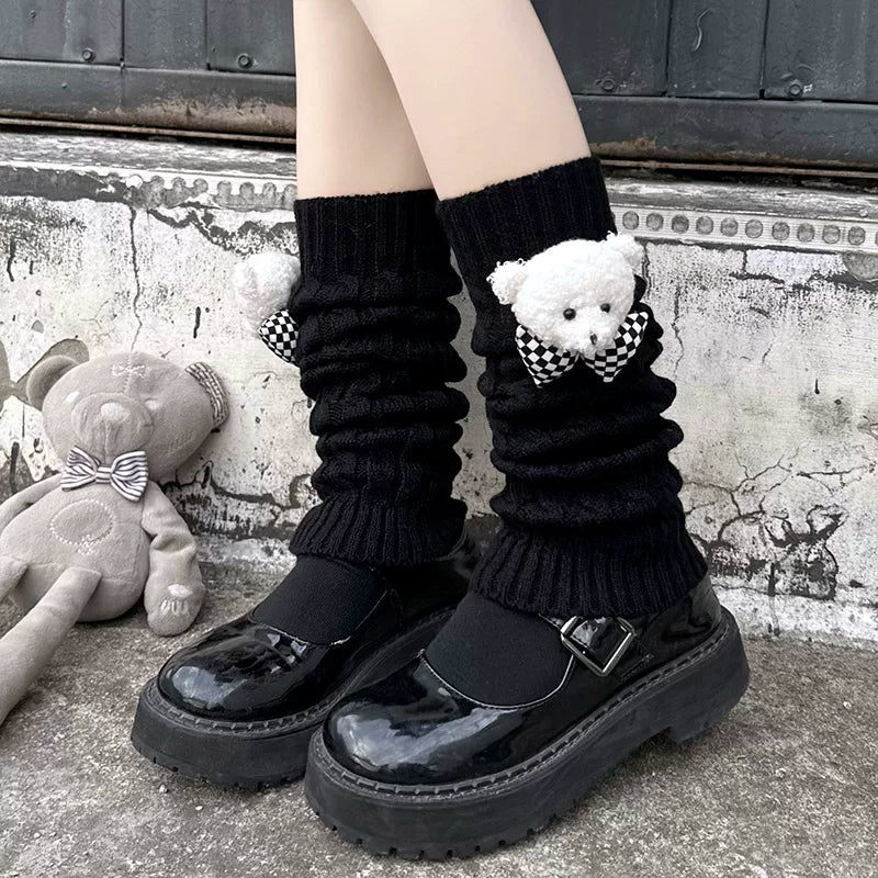 Black knitted leg warmers with teddy bear and check-pattern bow accents