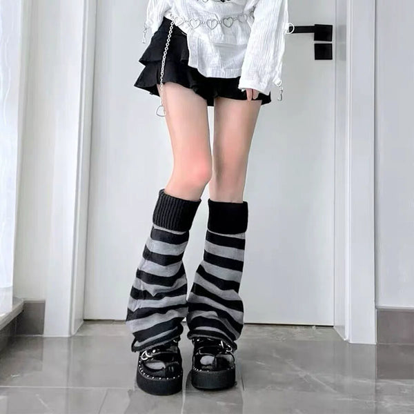 Black-gray striped leg warmers with ribbed cuffs styled with black platform shoes
