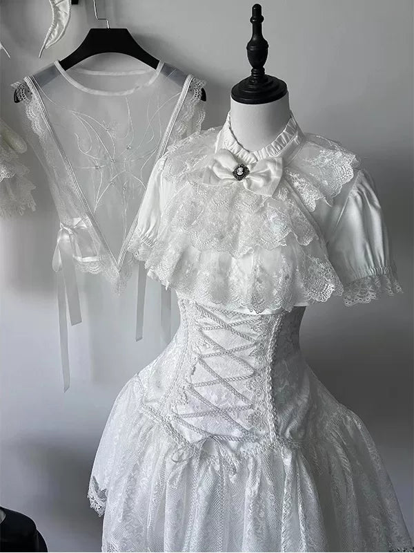 White blouse, lace bib and short skirt set displayed on a mannequin, with corset-style waist lacing.