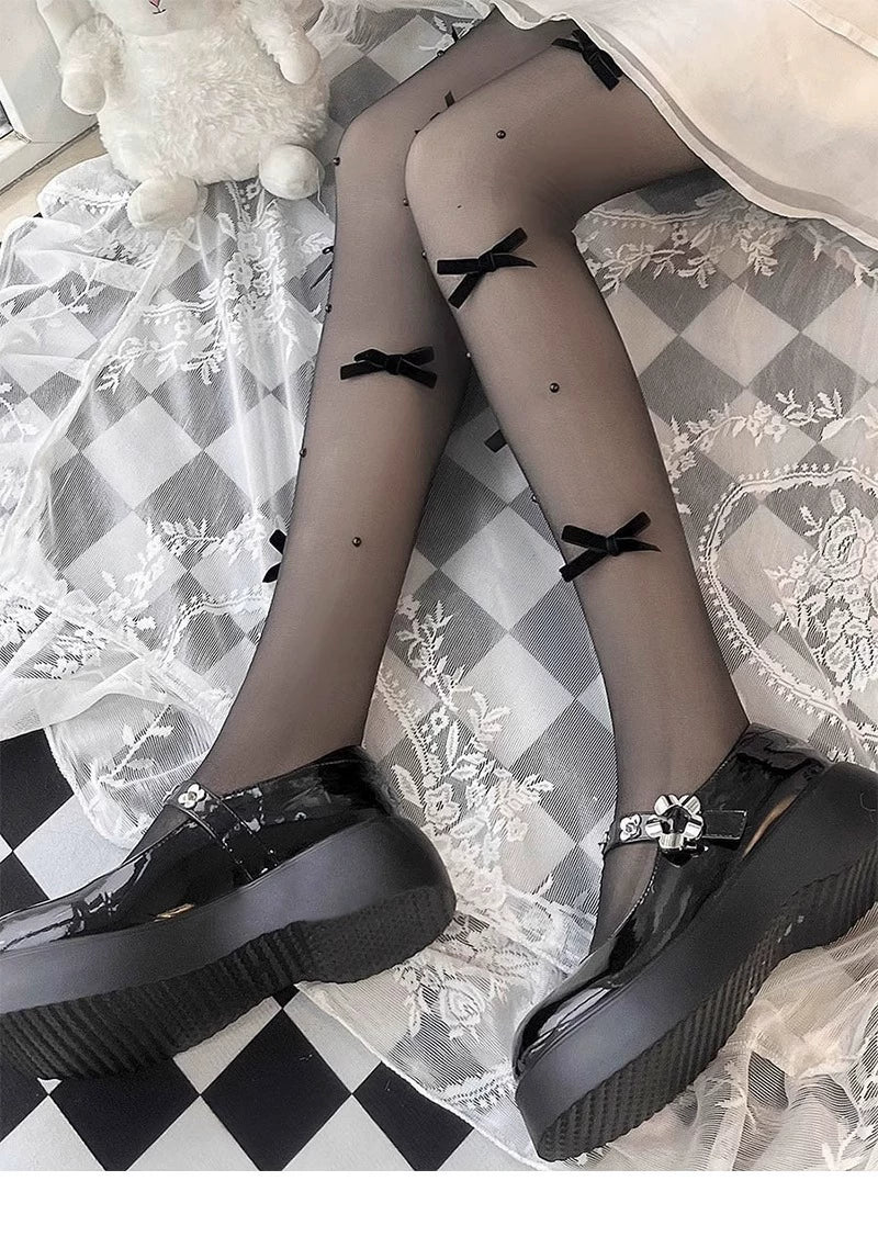 Model wearing sheer bow-detail pantyhose with black platform Mary Jane shoes