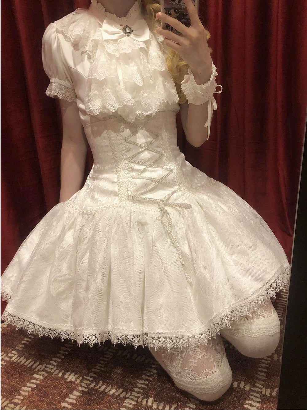 White Gothic Lolita blouse, half skirt, and bib set with lace trim and bow embellishment