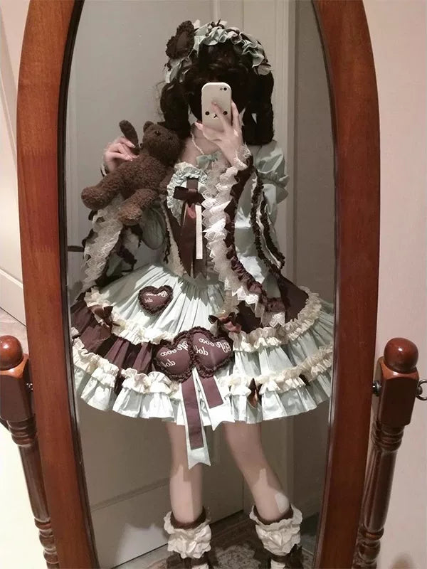 Mint-and-chocolate JSK set with hime sleeves, bows and a floral headpiece shown in a mirror.