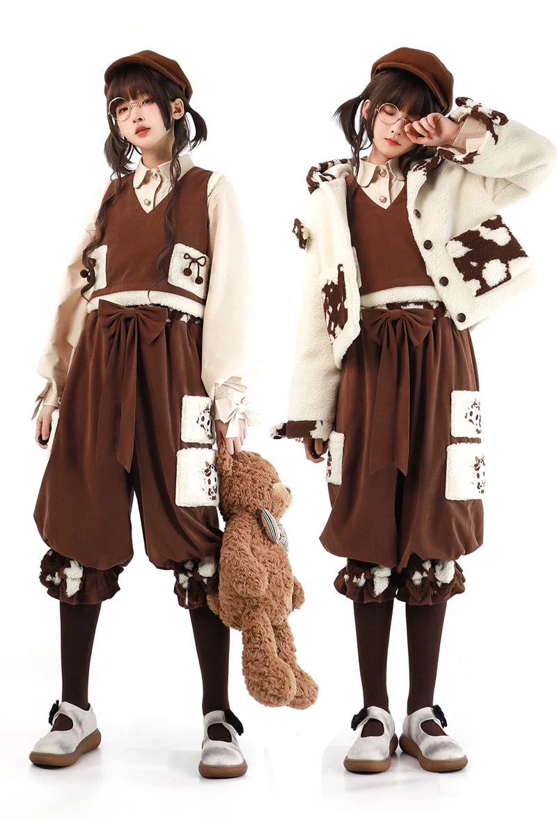 Brown-and-cream layered outfit with bear patches, a vest, and rounded pants shown on models.