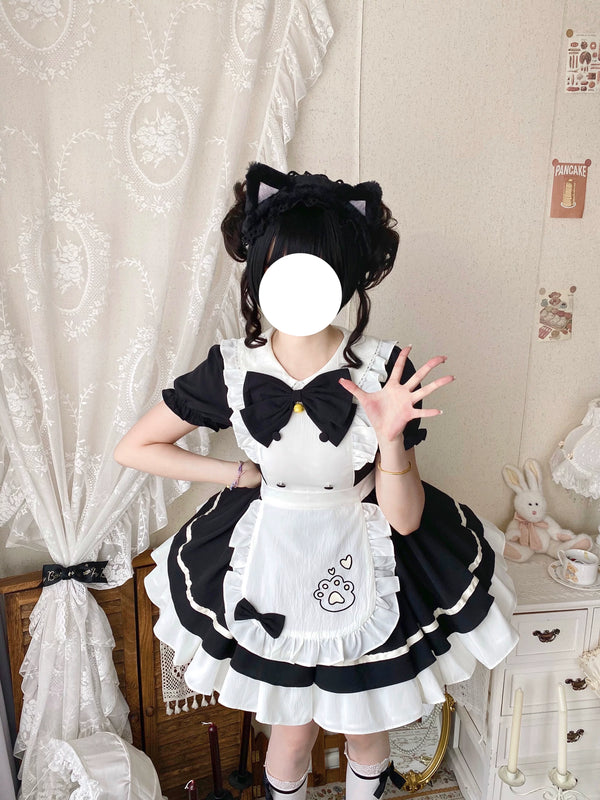 Black-and-white OP dress with a white ruffled apron and large bow