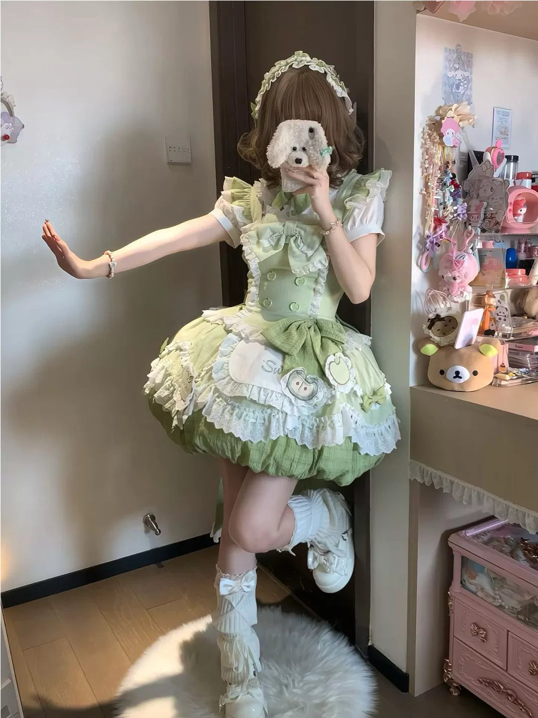 Green-and-white frilled Lolita dress set styled with a headpiece