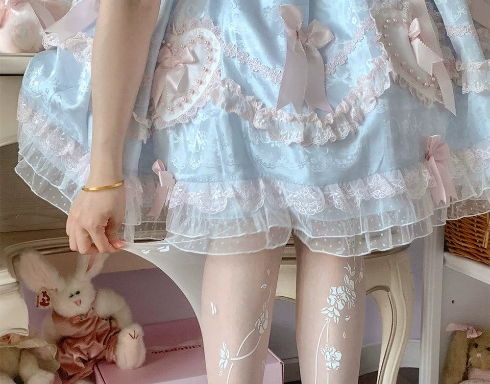Pastel blue skirt styled with white floral-print tights.