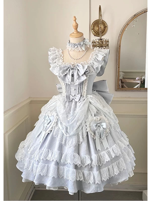 Blue-and-white lace Lolita dress displayed on a mannequin, with tiered skirt and oversized back bow.