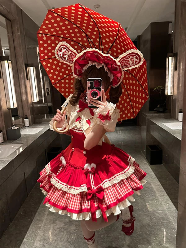 Red JSK dress set with gingham panels, cream ruffles and short-sleeve outerwear.