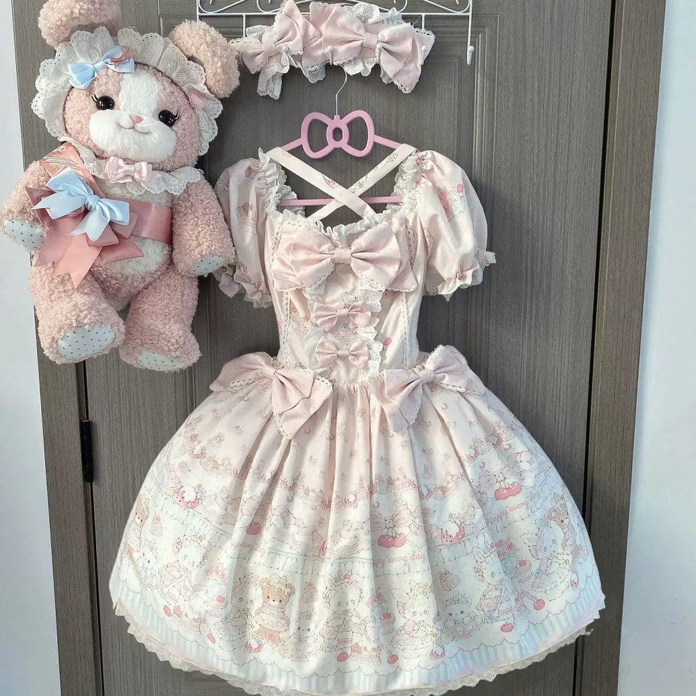 Pastel printed one-piece dress with oversized bows and lace trim on a hanger