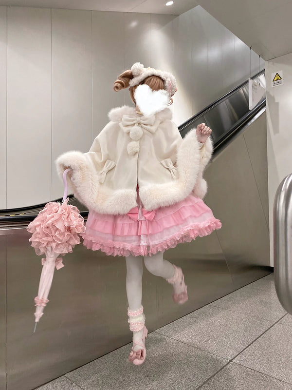 White Kitty Pompom cape shown in a supplier styling photograph.