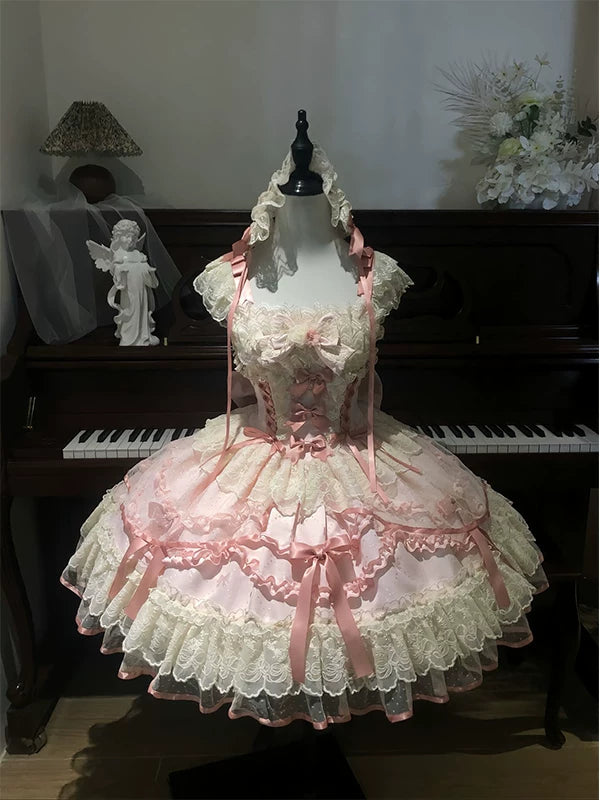 Pink and ivory lace JSK dress with a trailing train on a mannequin