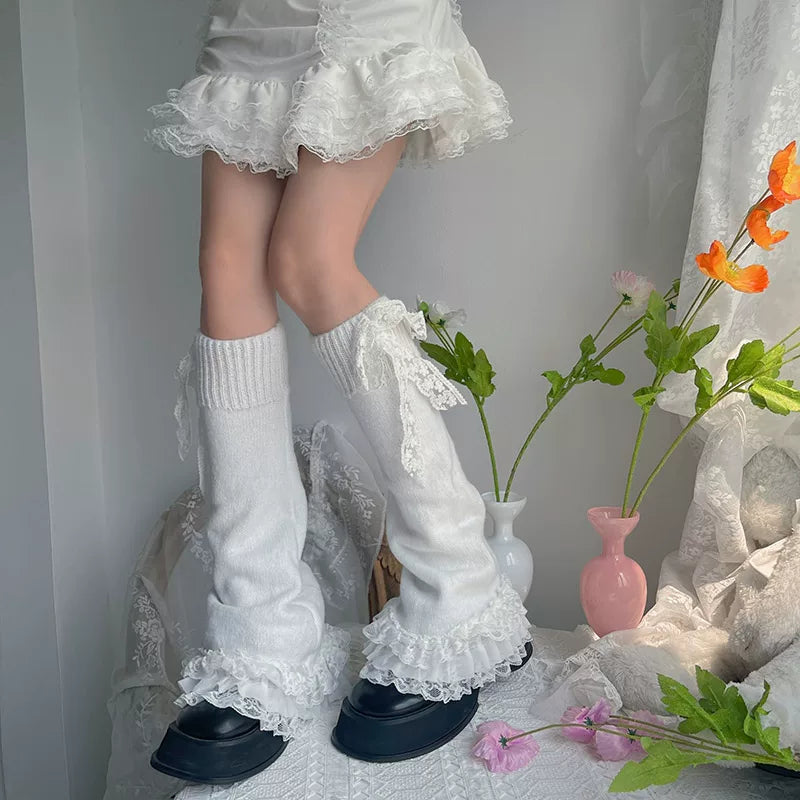 White flared sock covers with layered lace ruffles styled over black platform shoes.