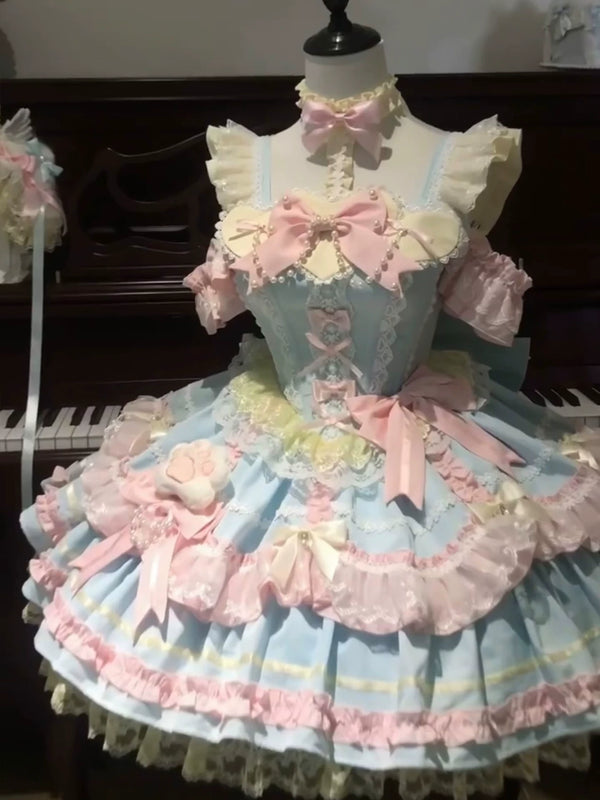 Pastel blue and pink JSK dress set displayed on a mannequin with layered ruffles and oversized bows.