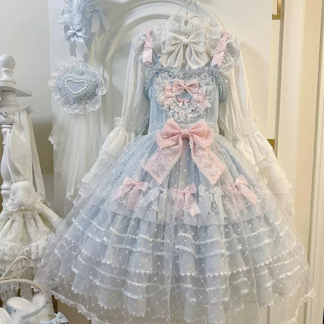 Lady Han Camellia Cherry Overture Sweet JSK Dress by Lolita Fetch featuring a floral cherry blossom pattern on a pink fabric.
