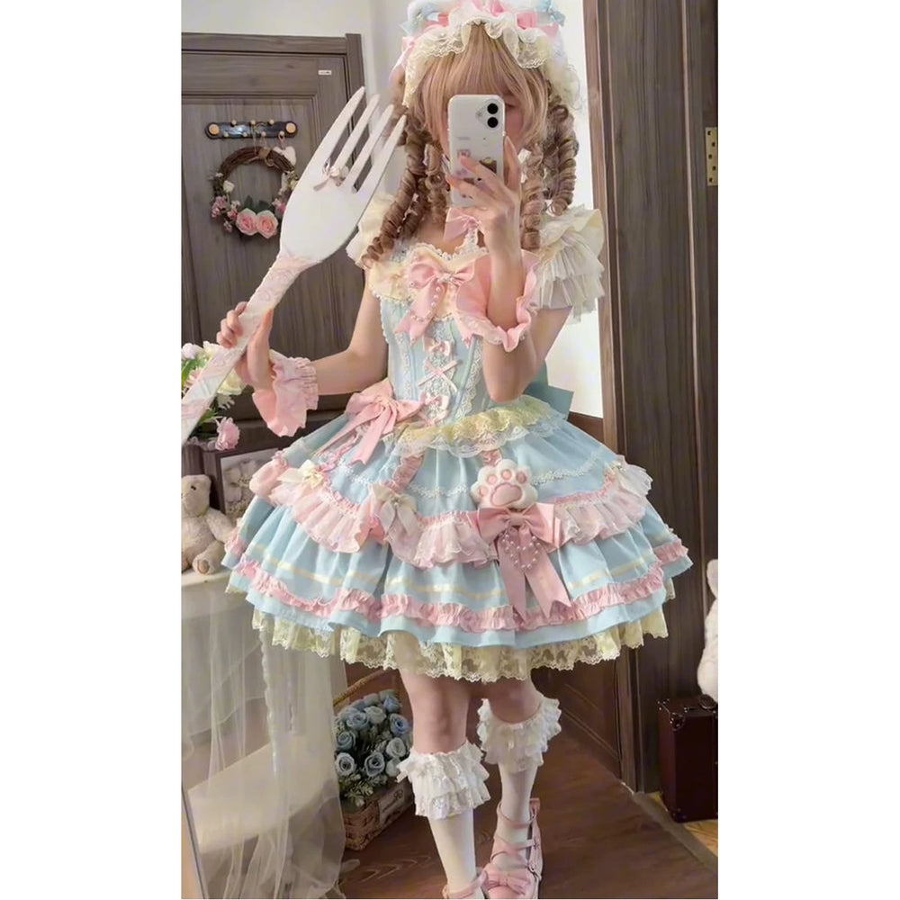 Blue-and-pink layered JSK dress with bows and ruffles worn in a mirror