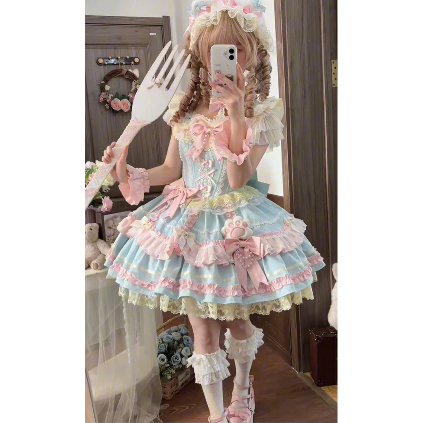 Blue-and-pink layered JSK dress with bows and ruffles worn in a mirror