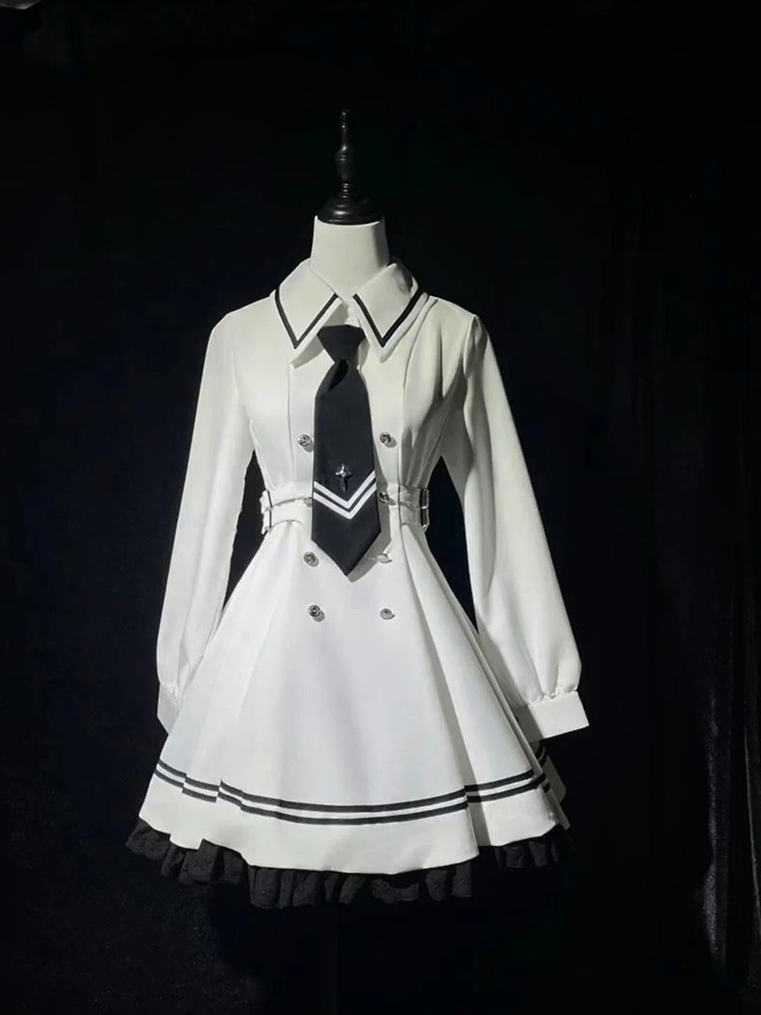 White OP dress and cape set with black piping displayed on a mannequin