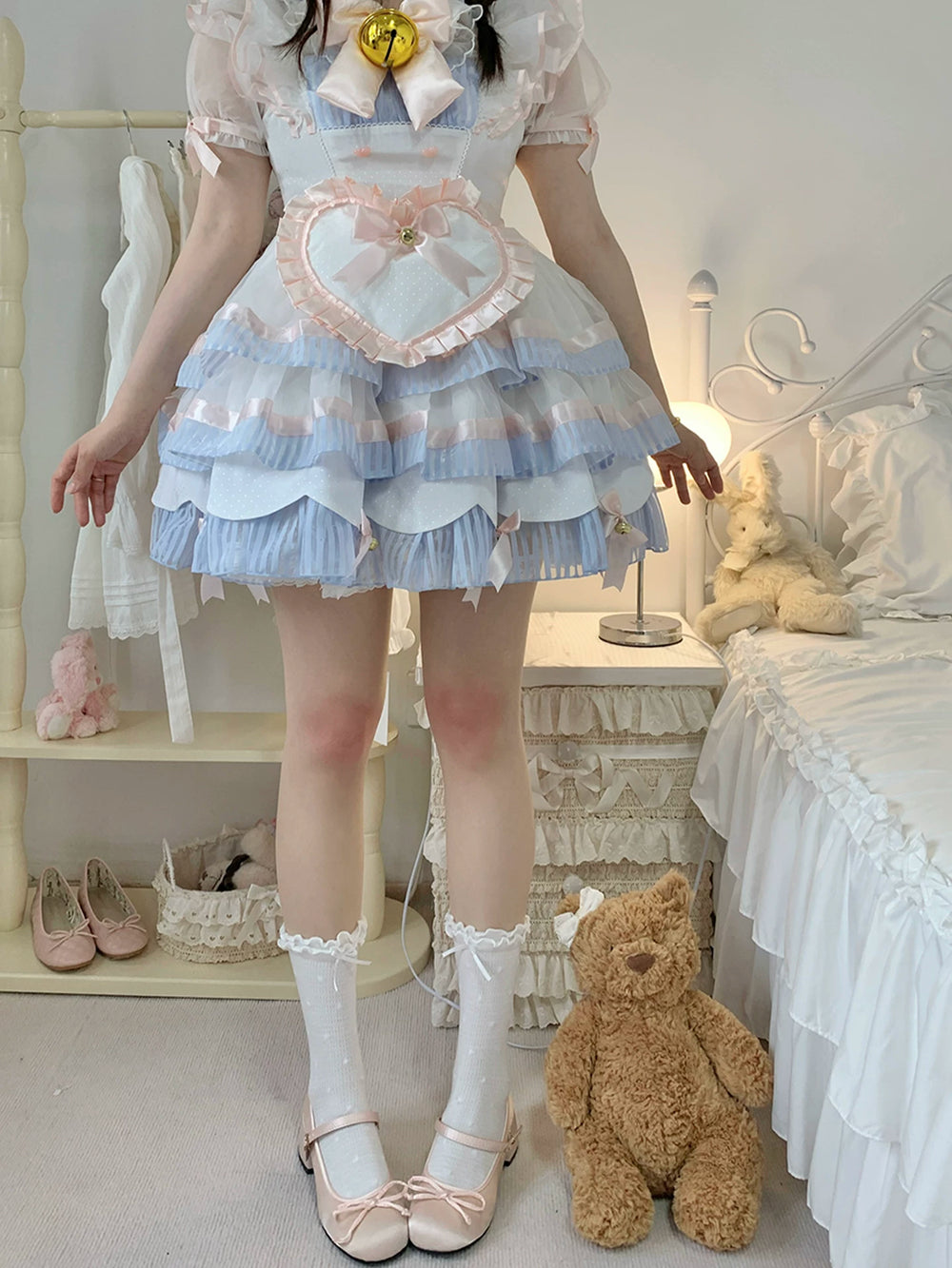 White printed tights worn with a pale blue and pink layered Lolita dress.