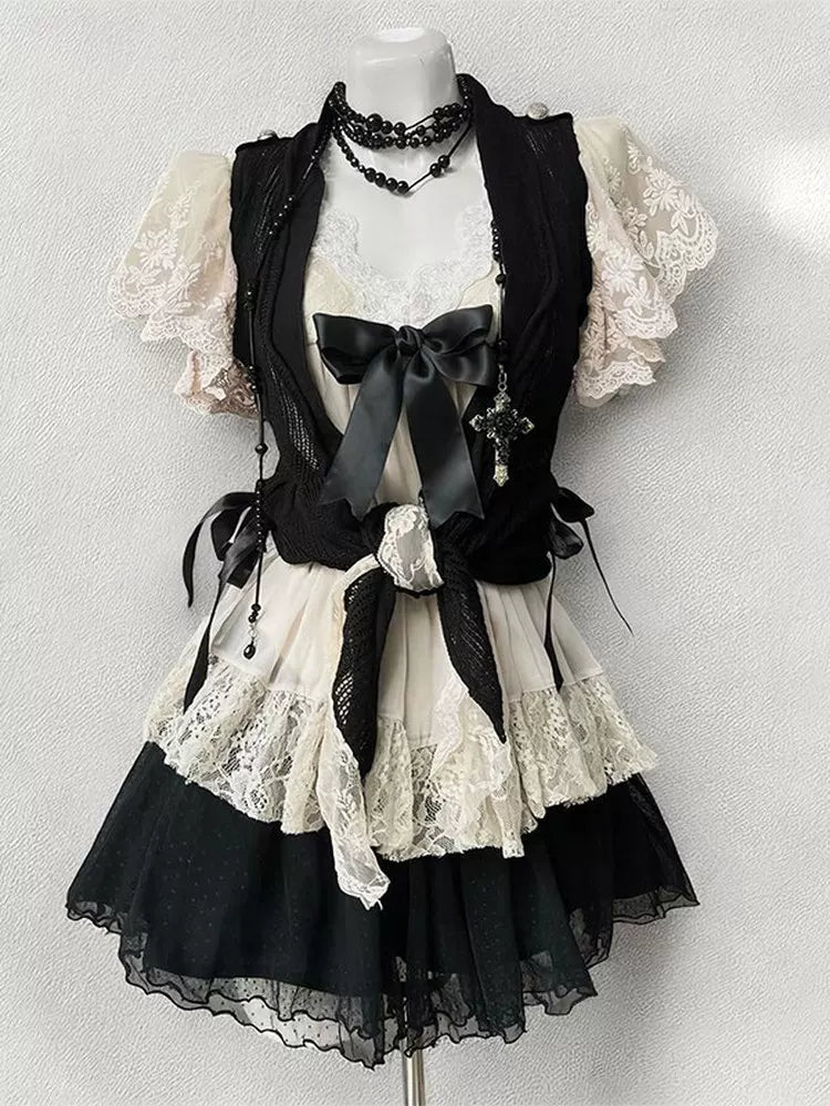 Black-and-ivory three-piece set displayed on a mannequin with lace and bow details