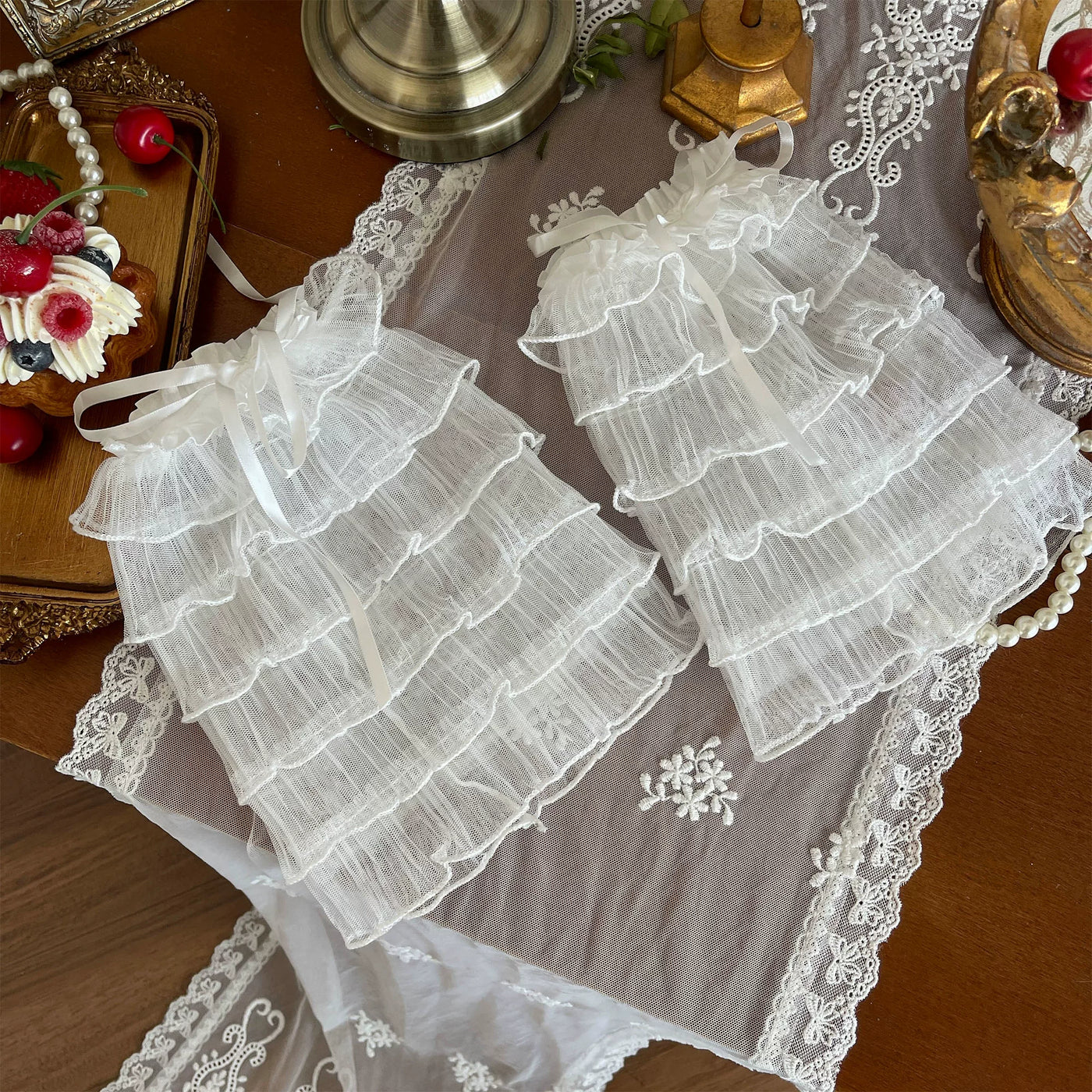 White lace stockings and layered mesh legwear styled with a white Lolita outfit