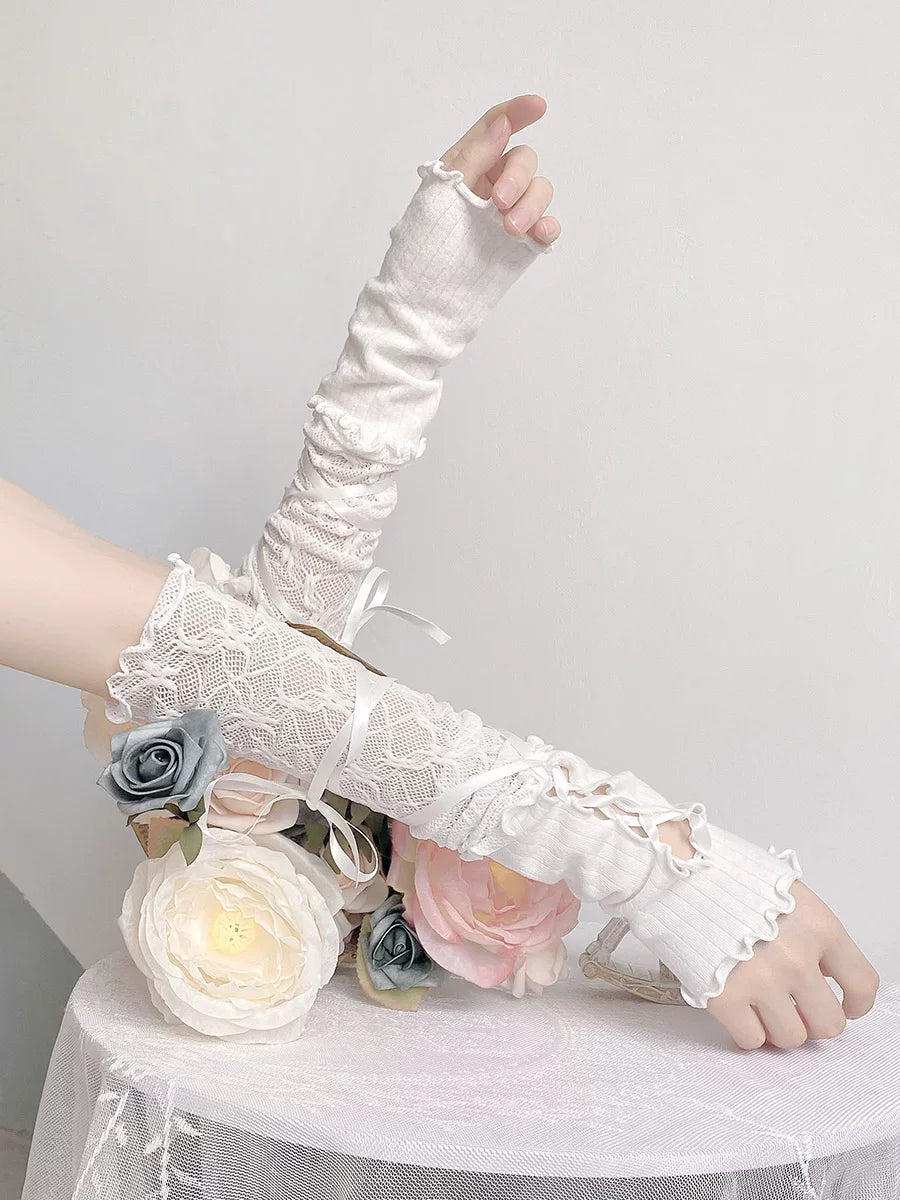 White fingerless lace arm sleeves with ribbon ties shown on arms.