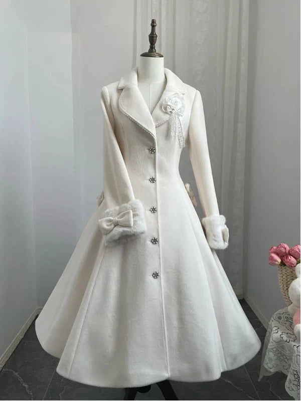Off-white flared Lolita coat on a mannequin with bow details and textured cuffs