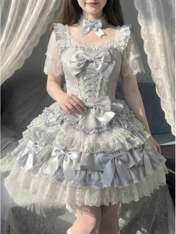 Blue and white Lolita dress with layered lace ruffles, oversized bows and a full skirt.