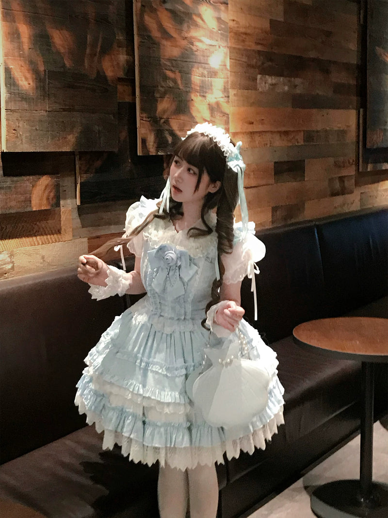 Tiered ruffled skirt of the pale blue JSK with white lace trim and scalloped hem