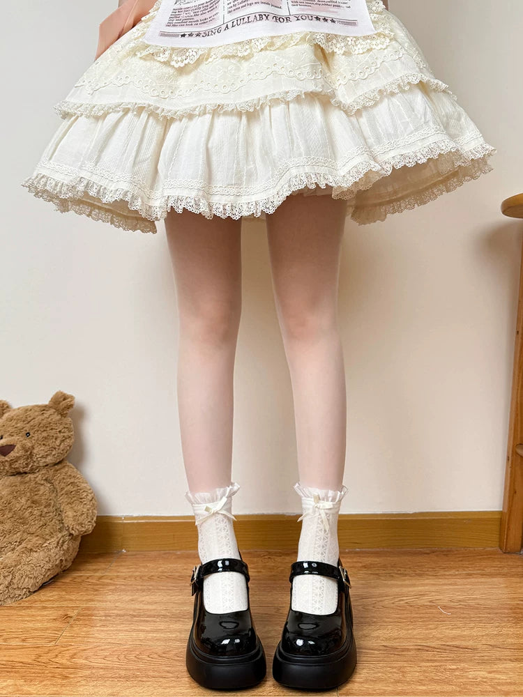 White gathered socks with bow or lace-trimmed cuffs shown above black Mary Jane shoes.