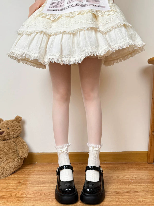 White gathered socks with bow or lace-trimmed cuffs shown above black Mary Jane shoes.