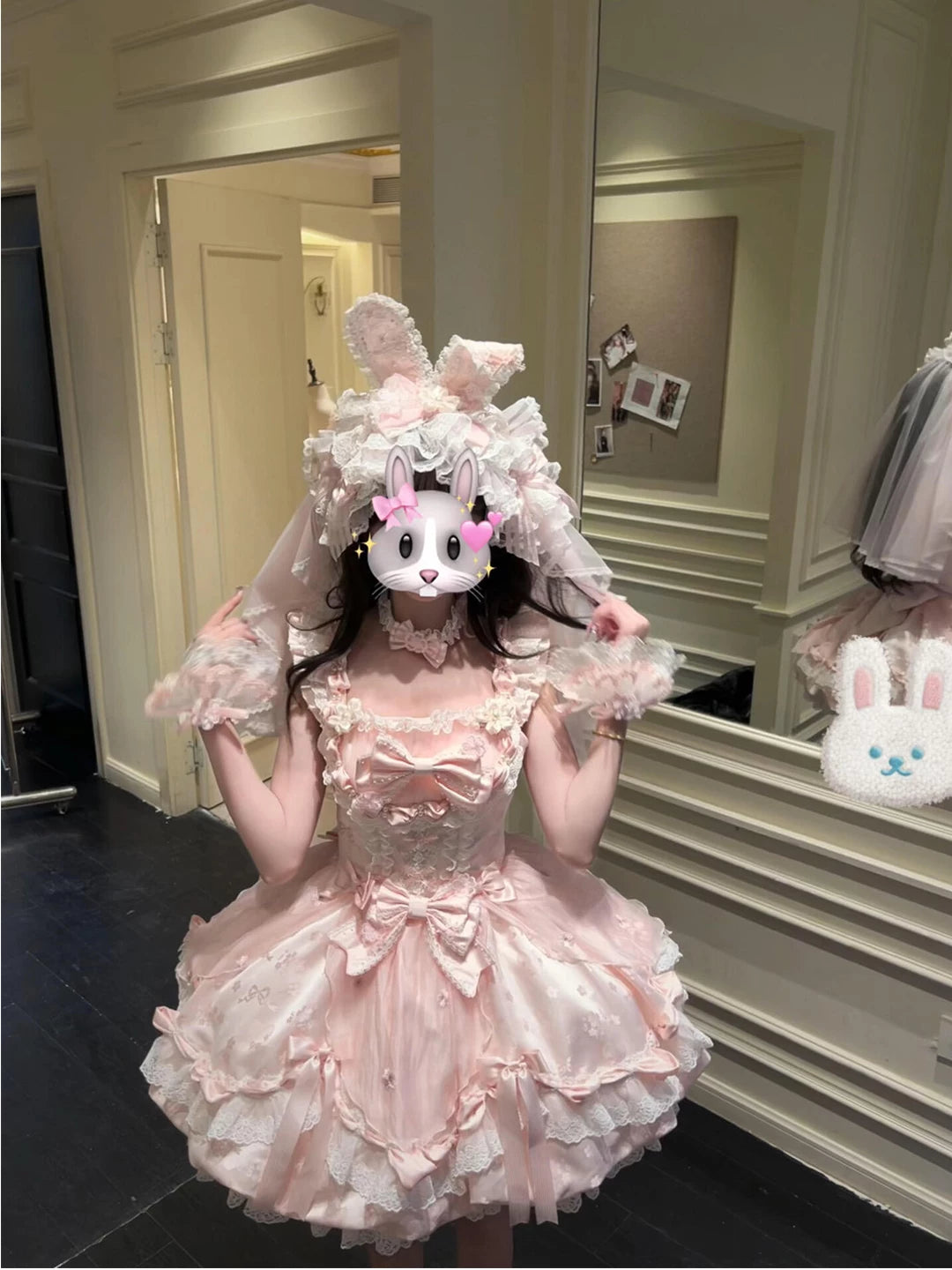 Close-up of lace trim and satin bow details on the pink lolita JSK bodice.