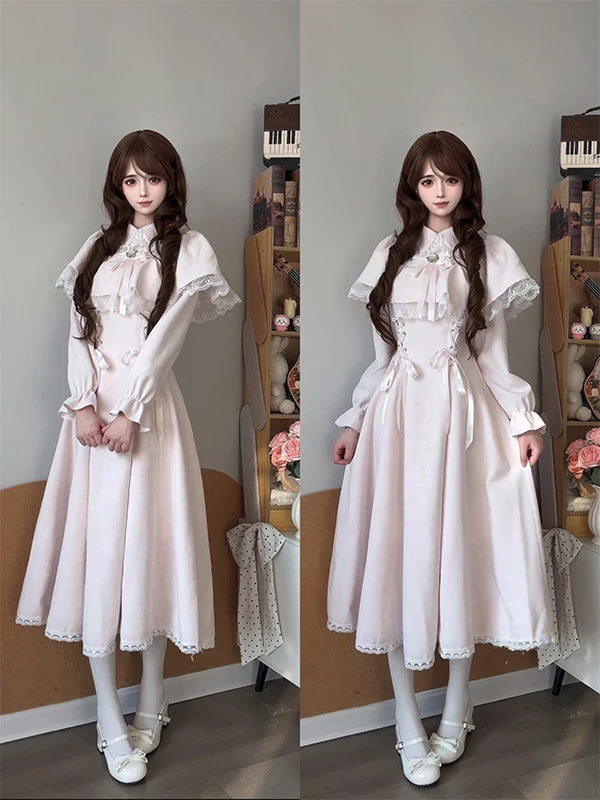 Pink Lolita dress with lace-trimmed bow cape overlay shown on a model.
