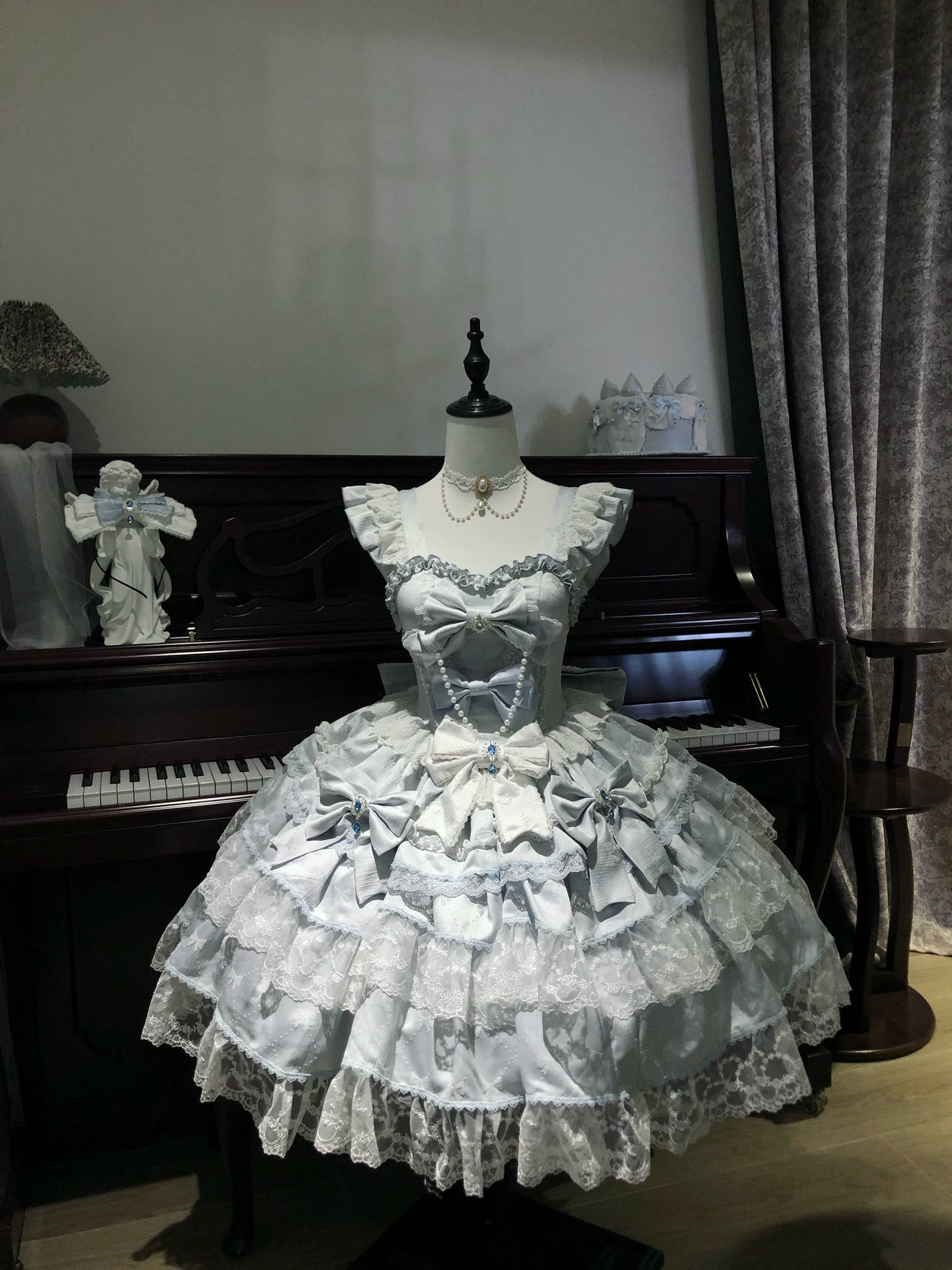 Soft pink Sweet Lolita OP dress with jacquard fabric, tiered skirt, and bow accents