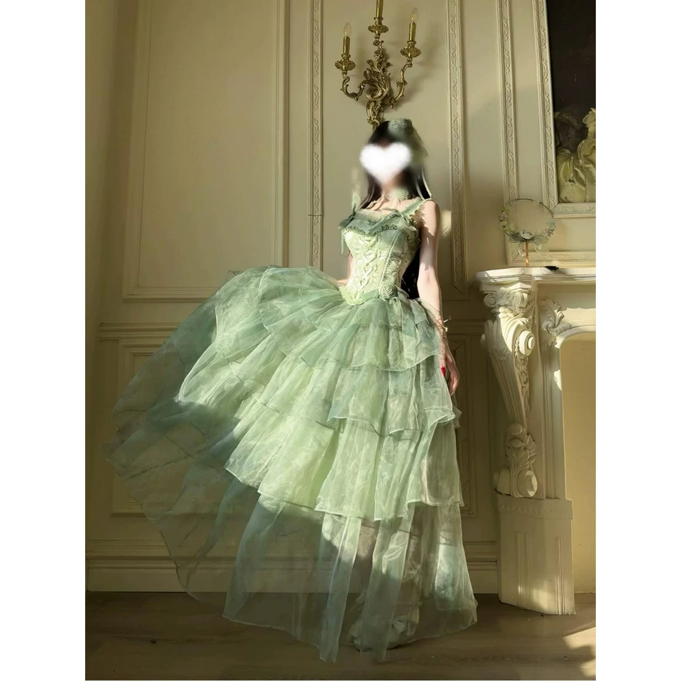 Model views of a mint-green tiered sheer gown with a fitted bodice and off-shoulder neckline.
