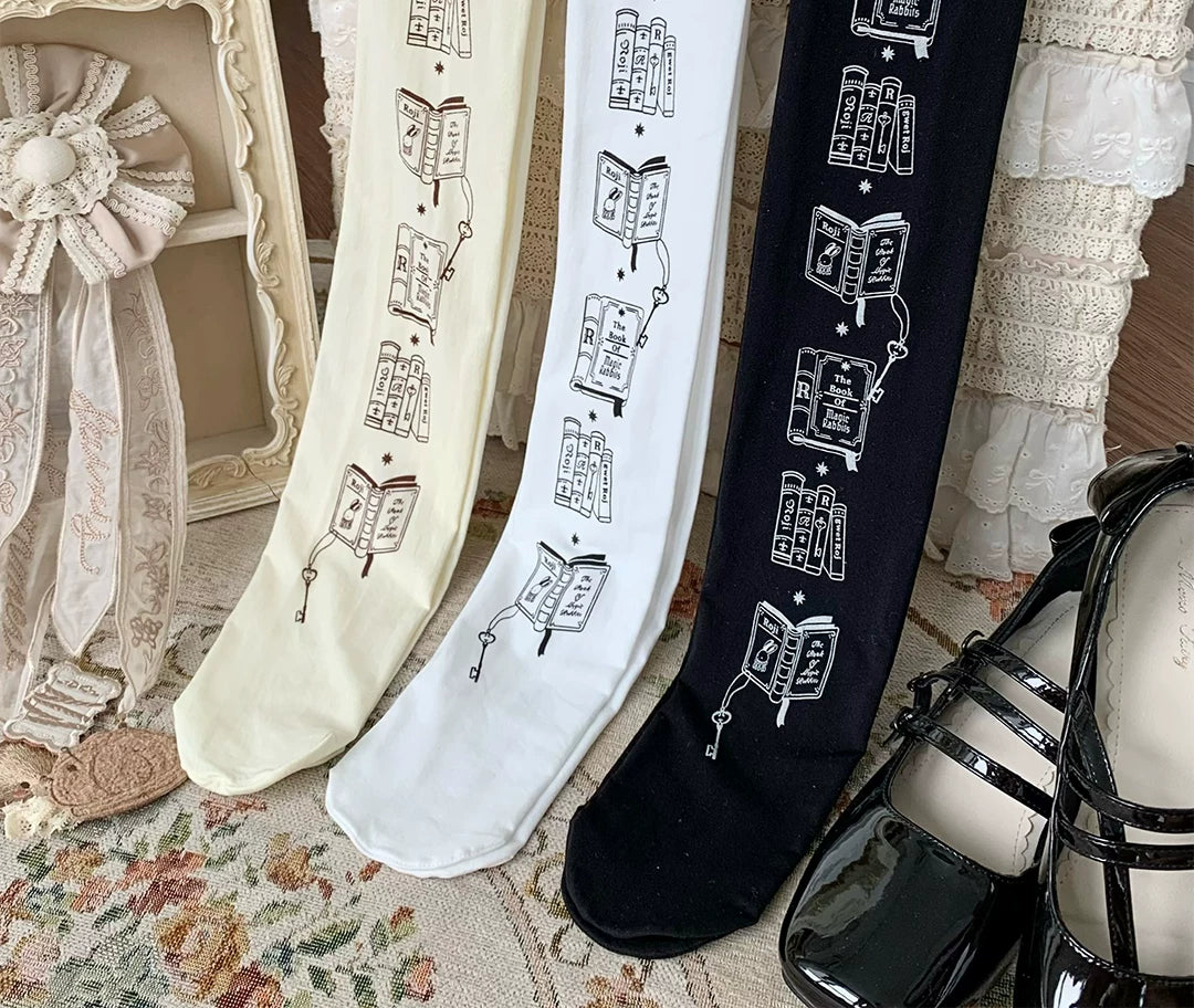 White, natural and black tights with repeating book and rabbit prints