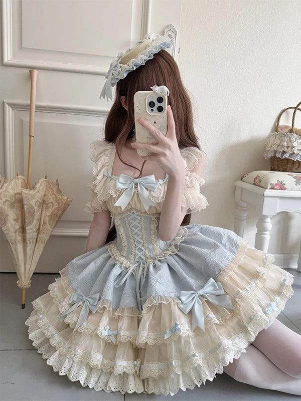 Creamy blue tiered JSK dress with cream lace, bows, and a full skirt.