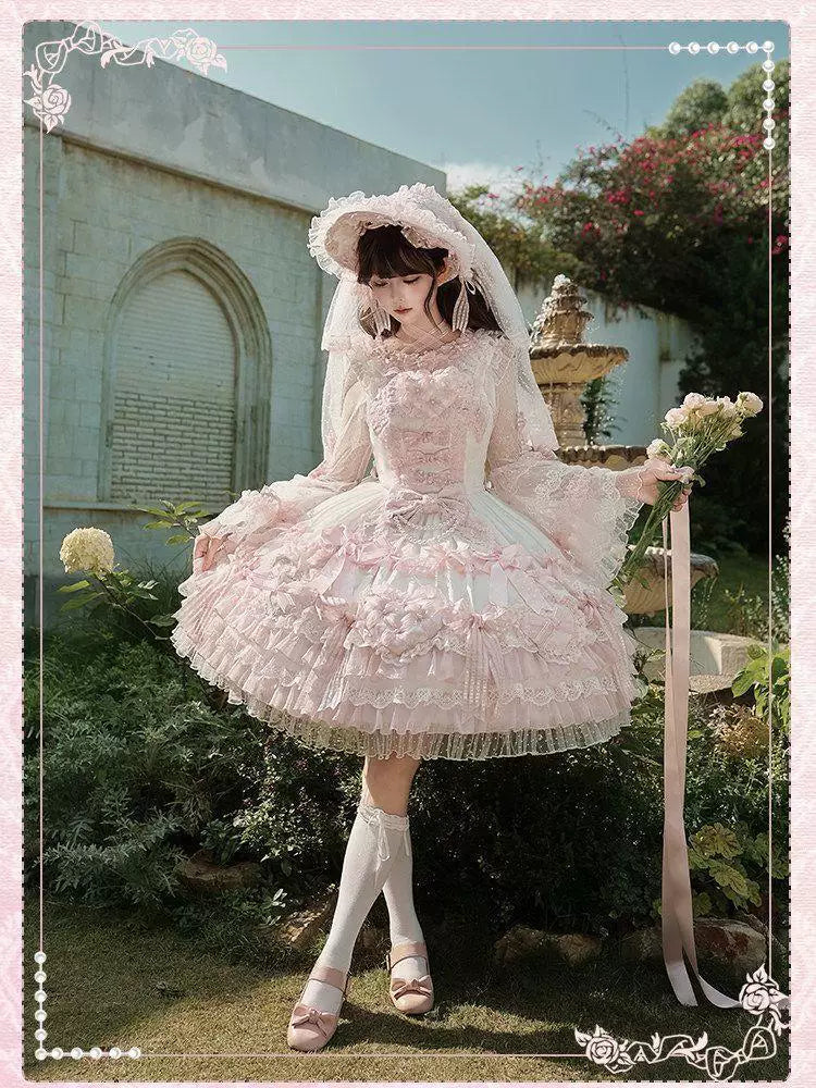 Lace-trimmed white and pink blouse with layered flared cuffs on a mannequin.