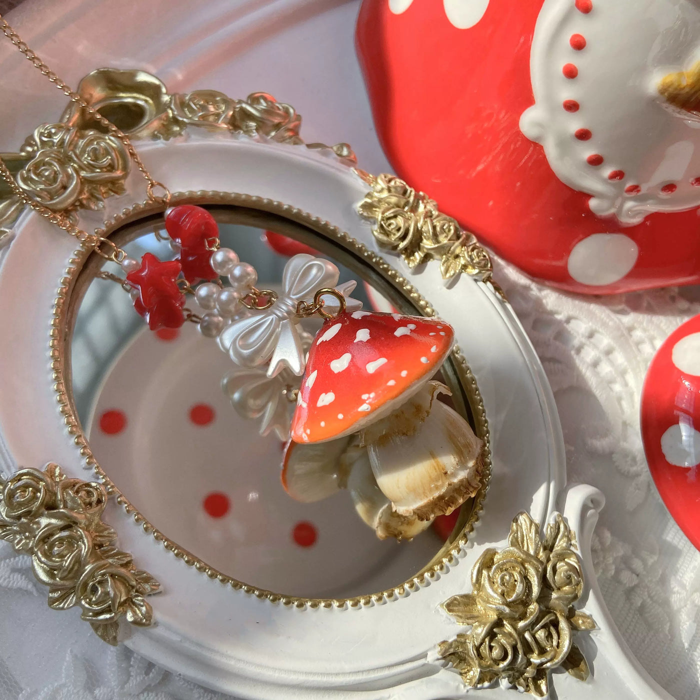 Bear doll mushroom necklace with a red spotted mushroom pendant and bow detail.