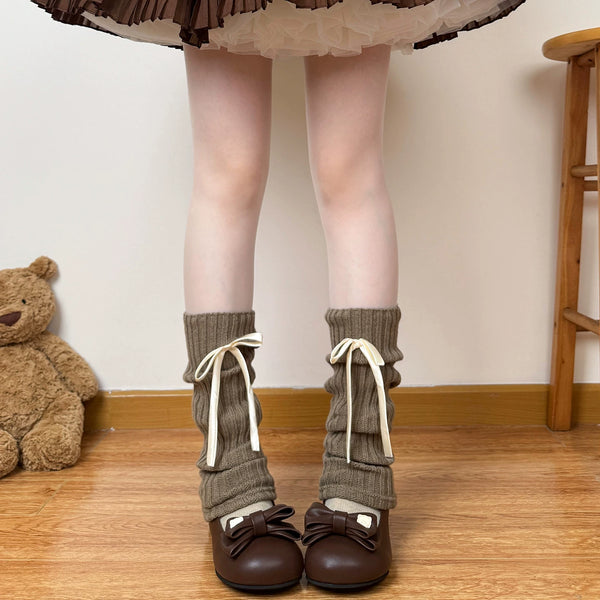 Off-white and Coffee brown ribbed leg warmers with white ribbon bows styled with brown platform shoes